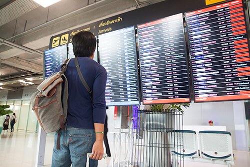 asian-traveler-man-with-backpack-carry-luggage-suitcase-looking-flight-schedule-suvarnabhumi-airport-beautiful-international-airport-bangkok1